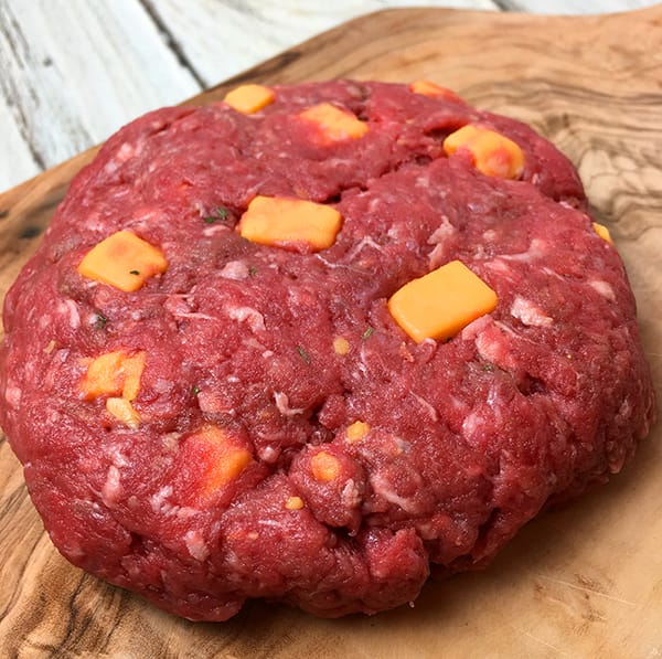a hamburger patty for a delicious Instant Pot cheeseburger loaded with cubes of cheddar cheese and ranch seasoning.