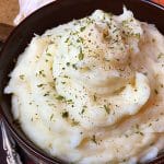 A bowl of mashed potatoes seasoned with garlic and ranch and made in an Instant Pot electric pressure cooker.