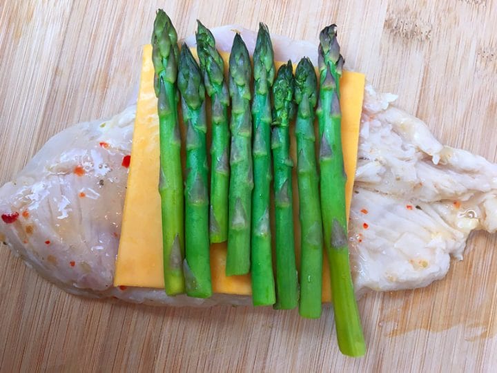 Making asparagus and cheddar stuffed chicken breast