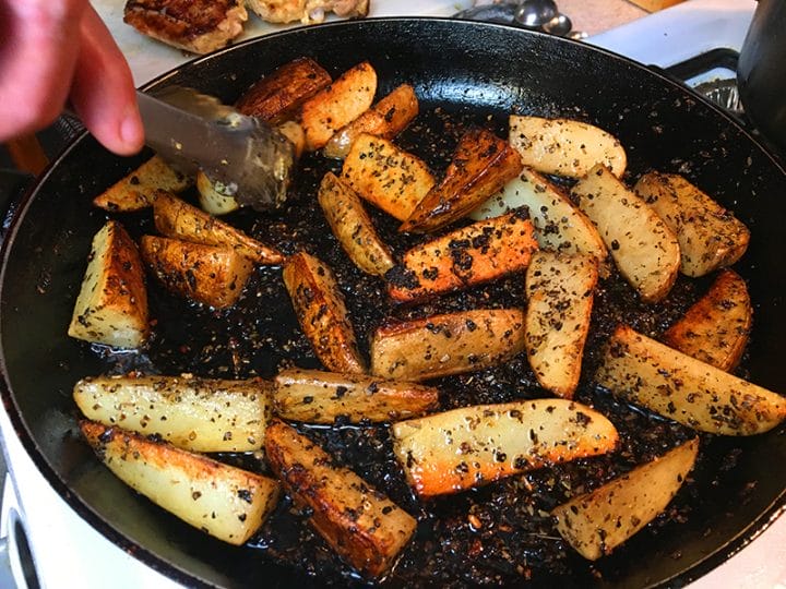 Potato wedges crisping in a pan before cooking with chicken thighs in an Instant Pot