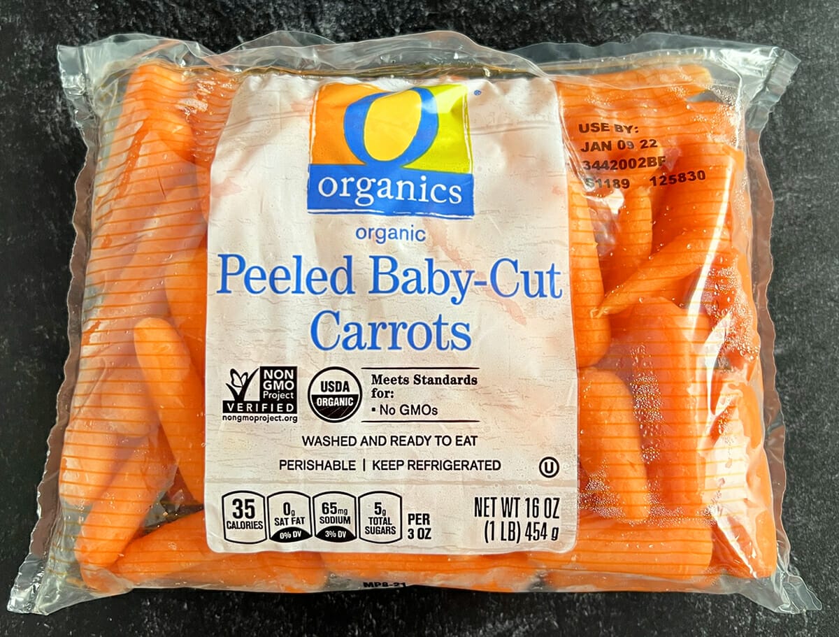 Adding brown sugar to baby carrots to roast in an air fryer.