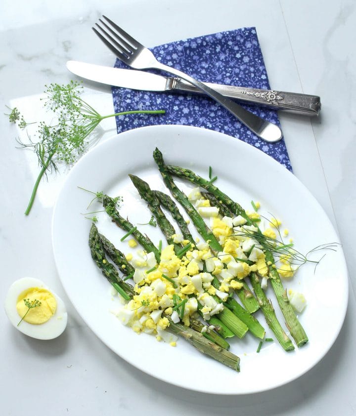 Air fryer hard boiled eggs diced and topped over asparagus.