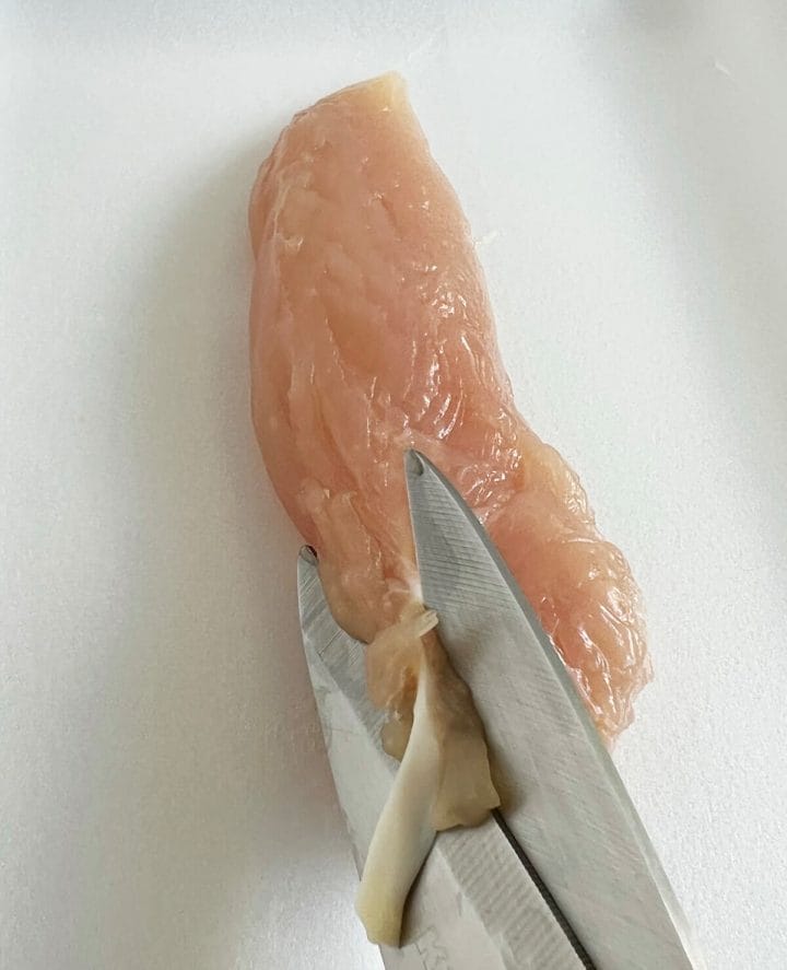 Cutting or removing the tendon from chicken breast tenderloins