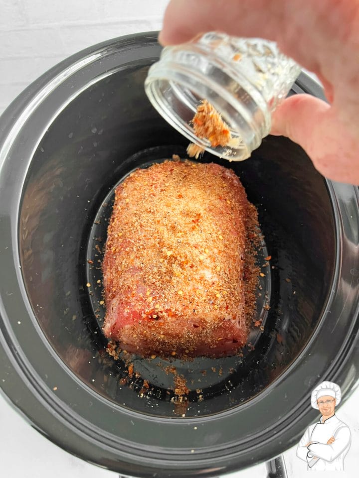 Tender, juicy, mouthwatering pork roast being seasoned to perfection.