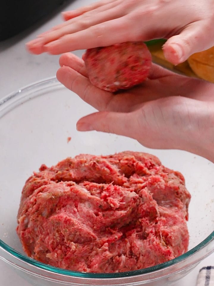 Rolling out the meatballs for our air fryer meatball sandwiches.