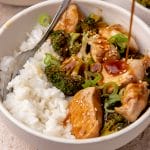 Serving teriyaki chicken and broccoli in a bowl with rice.