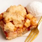 Apple pie bar served with vanilla ice cream and a gold colored fork.