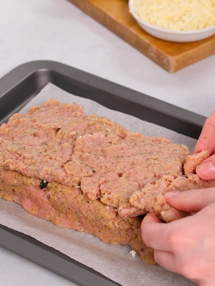 Creating the top layer for stuffed turkey meatloaf.