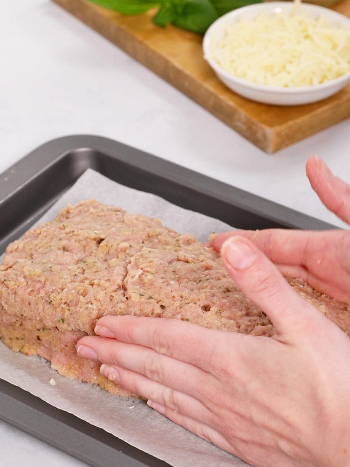 Forming our stuffed turkey meatloaf into the final loaf shape.