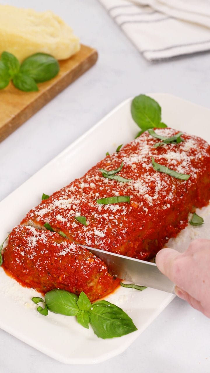 Slicing our mozzarella and spinach stuffed turkey meatloaf.
