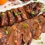 A platter of sliced pork tenderloin made in an air fryer and seasoned with a coffee citrus rub.