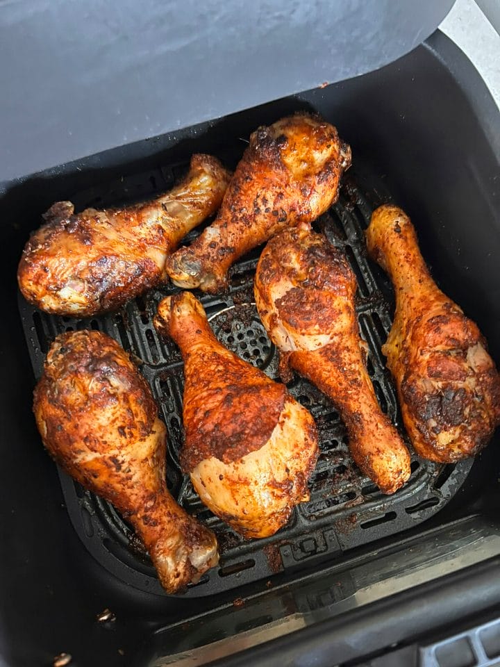 Blackened chicken drumsticks cooked in an air fryer.