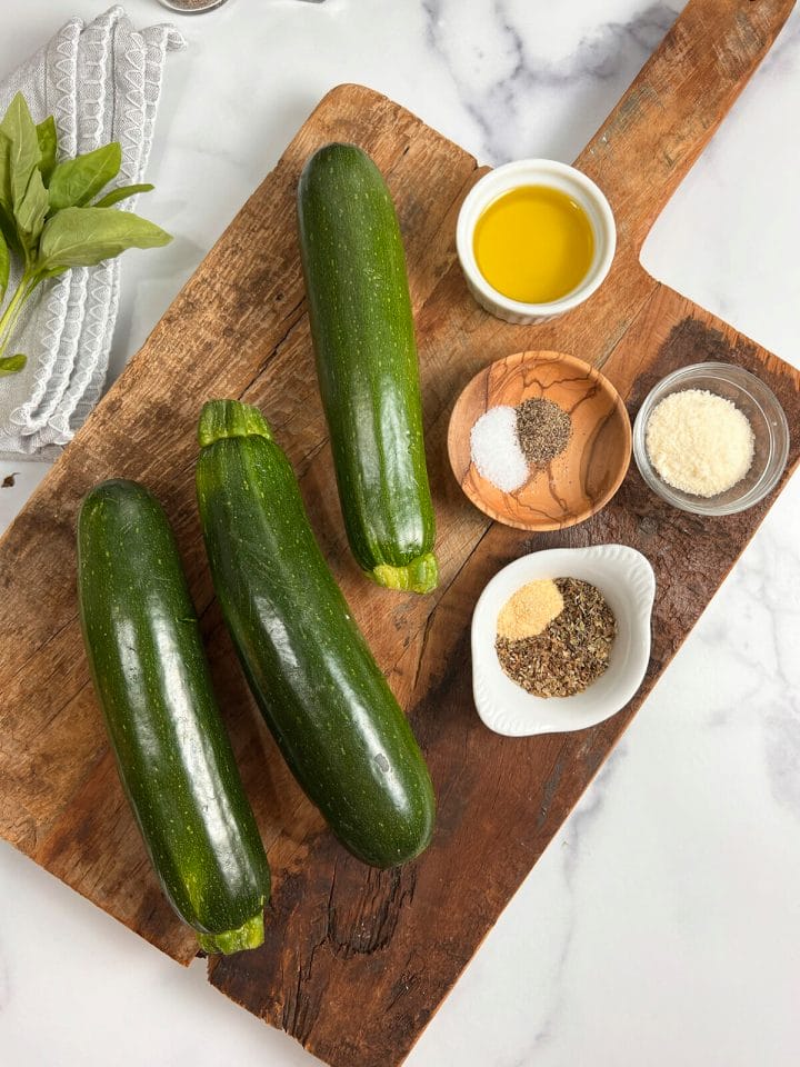 Fresh zucchini with other ingredients to make air fryer roasted zucchini.