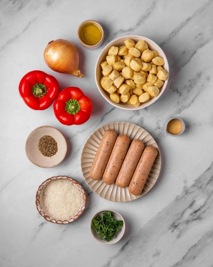 All the ingredients to make sheet pan gnocchi with sausages and peppers.