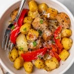 A bowl of sheet pan gnocchi with peppers and sausage.