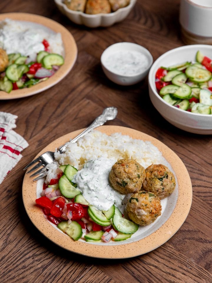 Air fryer Greek meatballs served with Greek salad and rice.