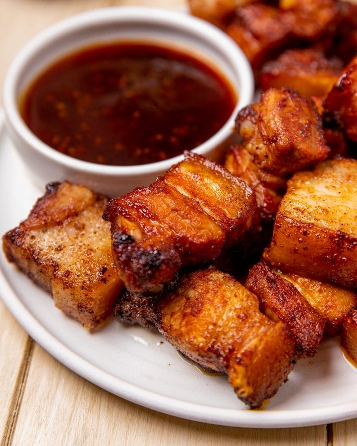 Mouthwatering air fryer pork belly bites served with a dipping sauce.