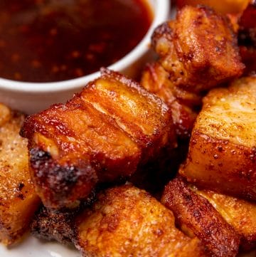 Air fryer pork belly bites made in an air fryer and served with a dipping sauce.