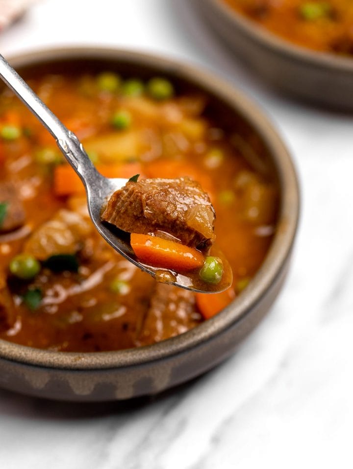 Beef stew on a spoon.