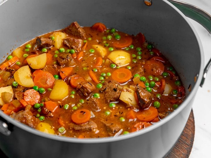 A Dutch oven filled with homemade beef stew.