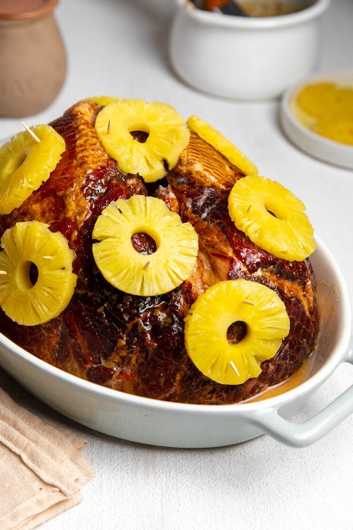 Baked ham with maple and brown sugar glaze and pineapples