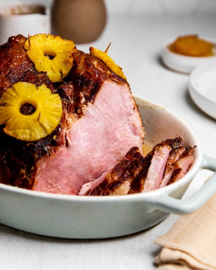 Sliced baked ham with pineapple and a maple and brown sugar glaze.