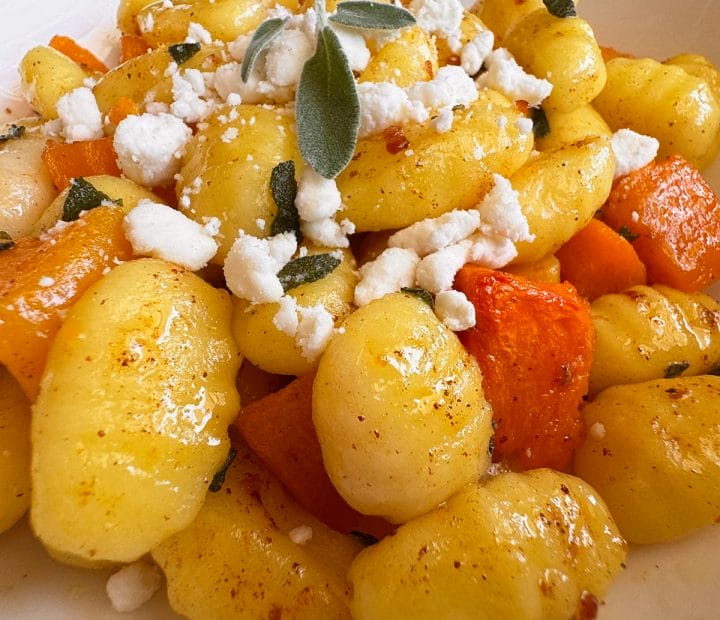 Cooked gnocchi with roasted butternut squash topped with a brown butter sage sauce and goat cheese crumbles.