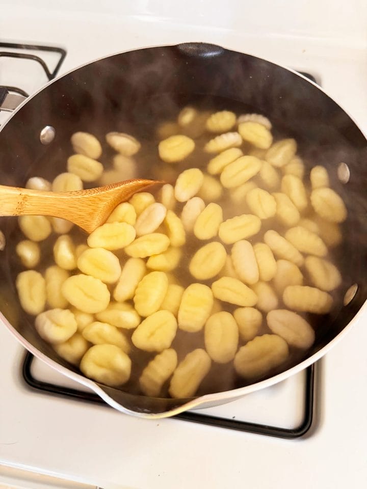 Gnocchi boiling in a pot of water.