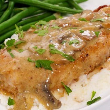 Thick and juicy pork chops are seared to golden perfection and then nestled into a savory, creamy mushroom and onion gravy.